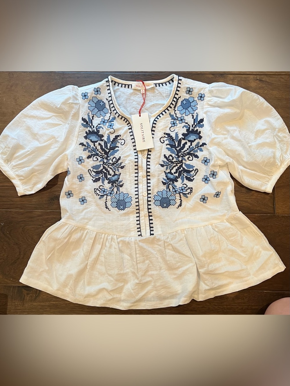 SOLITAIRE White Peplum Top with Blue Floral Embroidery